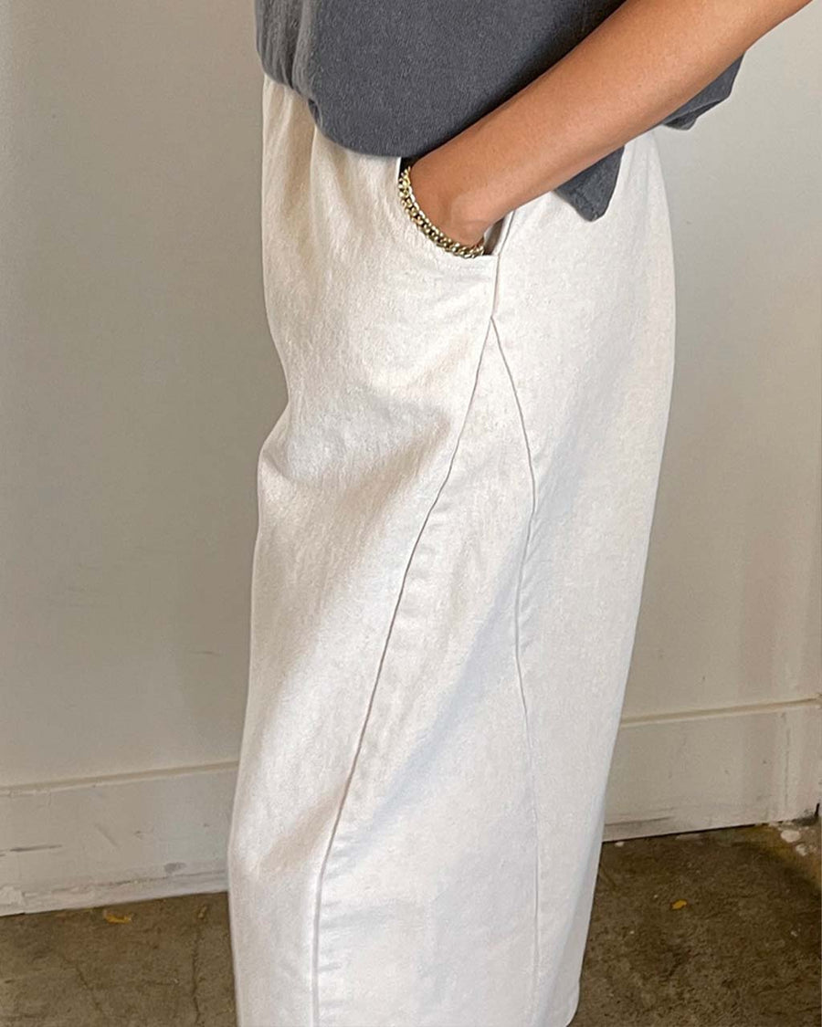 side view of model wearing cream cotton pants