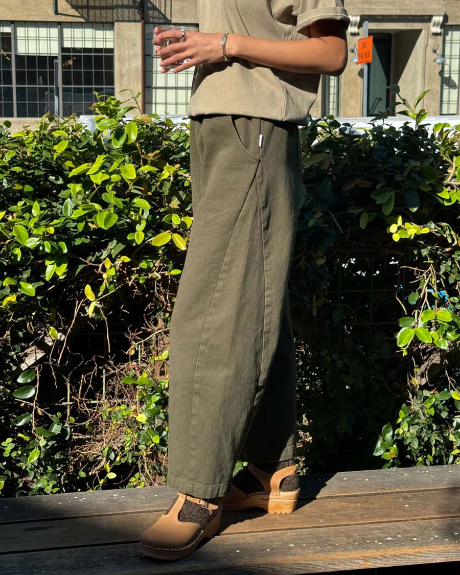 side view of model wearing olive relaxed fit pants
