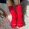model wearing strawberry red socks with high cuff