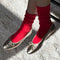 model wearing strawberry red socks with high cuff and silver ballet flats
