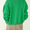 back view of model wearing buttoned spring green cotton cardigan