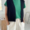 model wearing black knit open front 'granny' sweater vest