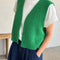 model wearing spring green knit open front 'granny' sweater vest