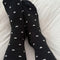model wearing tall black socks with dainty white hearts