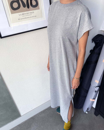 model wearing heather grey cotton maxi dress with muscle sleeves and side slits