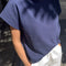 side view of model wearing midnight blue relaxed fit cotton tee