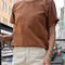 model wearing copper cotton vintage boy tee with slight distressing on the neckline and sleeves