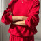 model wearing candy apple red pointelle sweatshirt with banded bottom