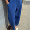 model wearing blue azure arc pants with side pockets and side leg panels