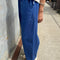 side view of model wearing blue azure arc pants with side pockets and side leg panels