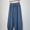 cornflower blue cotton balloon pants on a wooden hanger