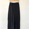 black cotton wide leg pants with side inlets on a hanger