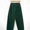 dark green corduroy arc pants with side panels and pockets on a hanger