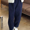 model wearing navy corduroy arc pants with side panels and pockets