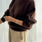 side view of model wearing dark brown mohair pull over sweater