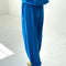back view of model wearing lagoon blue french terry balloon pants with side pockets and side panels