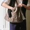 model carrying leopard print rectangular bag