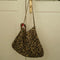 leopard print rectangular bag hanging on a door handle