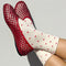 side view of model wearing white socks with red polka dots