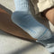 bottom of model wearing light blue socks with cushioned cuff