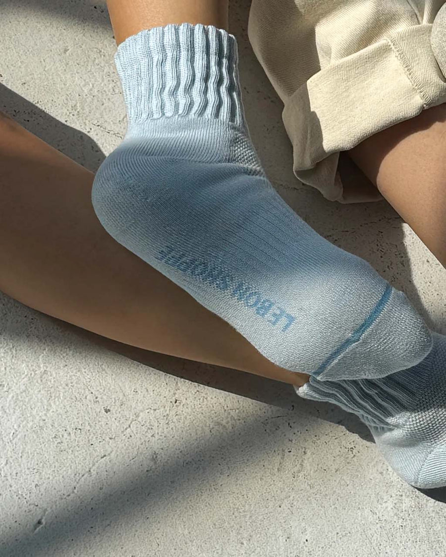bottom of model wearing light blue socks with cushioned cuff