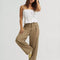model wearing tan brown slouch chino pants with pleated front