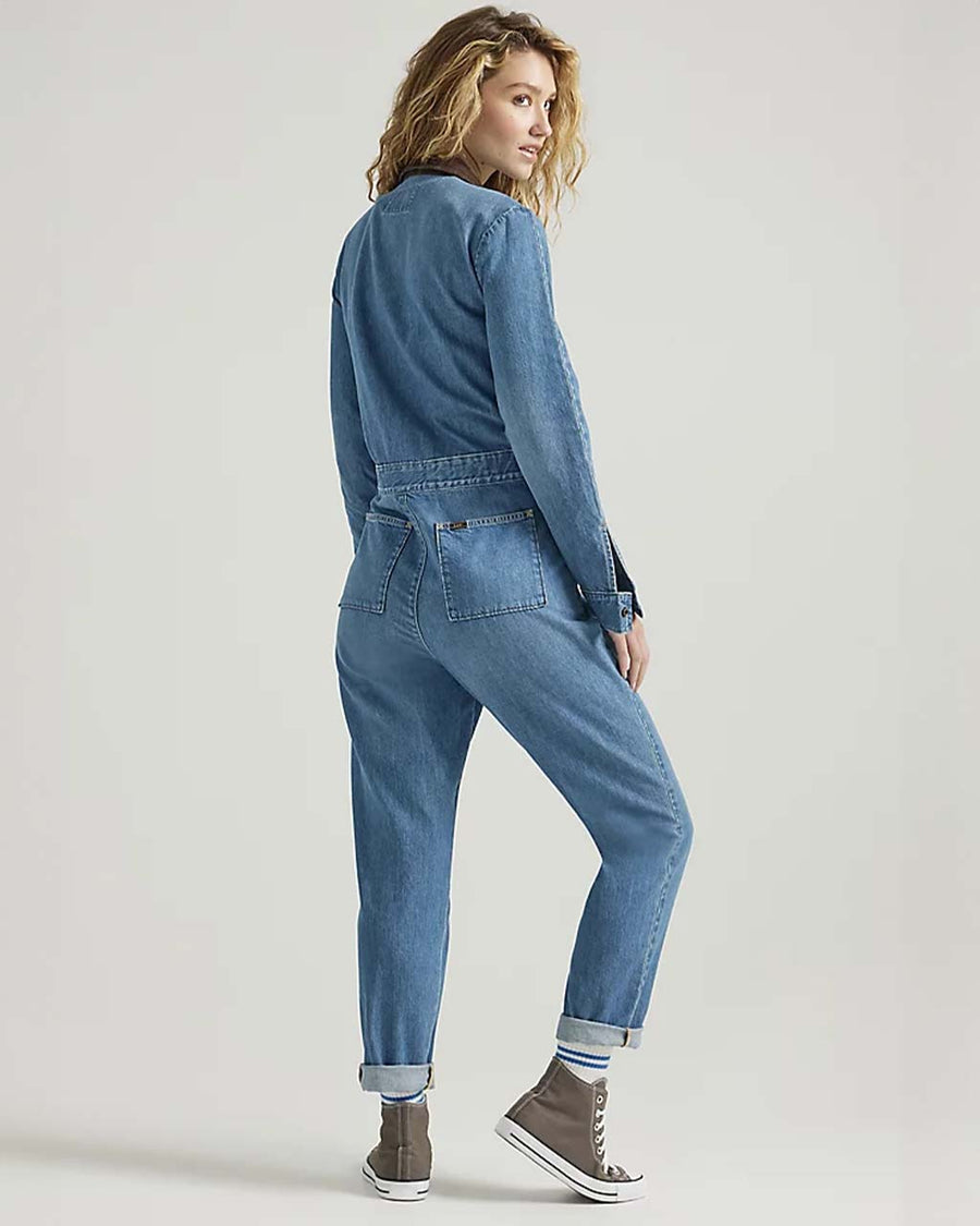 back view of model wearing denim union-all with zipper front and brown corduroy collars