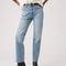 up close of model wearing medium denim slightly relaxed straight leg jeans with cream blouse