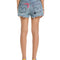 back view of model wearing distressed denim shorts with colorful patches on the side