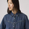 up close of model wearing western dark denim short sleeve button down top