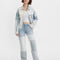 model wearing light and medium color patchwork denim jeans
