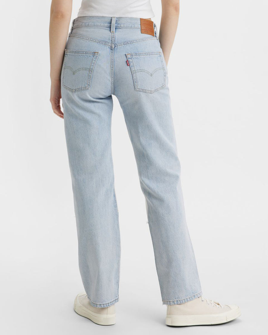 backview of model wearing light and medium color patchwork denim jeans
