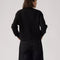 back view of model wearing black textured cardigan with shell buttons