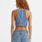 back view of model wearing cropped denim sleeves top with deep V neckline and two button closure