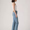 side view of model wearing light denim wedgie straight jeans