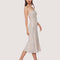side view of model wearing thin strap silver sequin midi dress with back cutout