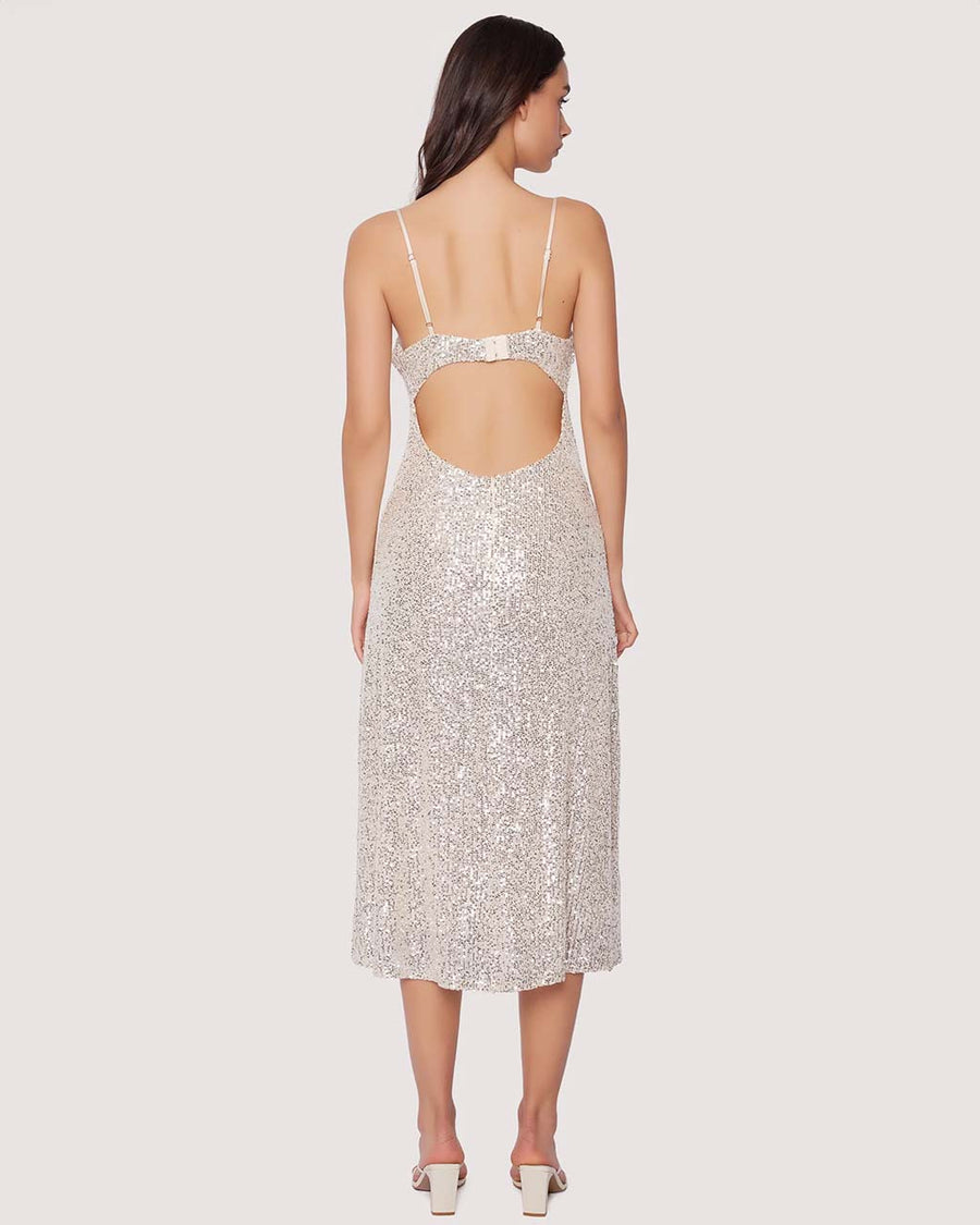 back view of model wearing thin strap silver sequin midi dress with back cutout