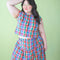model wearing colorful plaid button front cotton tank and matching skirt
