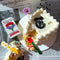 set of three colorful wildflower acetate cutlery utensils with matching tin holder on newspaper