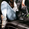 model holding black leather bucket bag