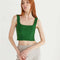 model wearing clover green structured sleeveless crop top with piping detail.
