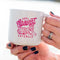 up close of model holding white ceramic mug with hot pink 'CATS AGAINST CATCALLS' with a tiger on it