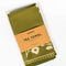 packaged olive green tea towel with white floral silhouette pattern