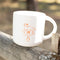 white ceramic mug with orange person holding a horse with 'HOLD UR HORSES' on it