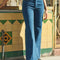 model wearing high waisted dark denim flare jeans