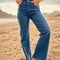 model wearing high waisted dark denim flare jeans