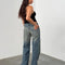 back view of model wearing blueish-green low rise wide leg denim