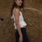 side view of white gathered cropped tank with ruffle bust and tie waist