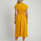 back view of model wearing yellow seer sucker midi dress with short sleeves and two tie bodice front