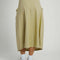 back view of model wearing moss midi skirt with rounded ruffle detail on the hips